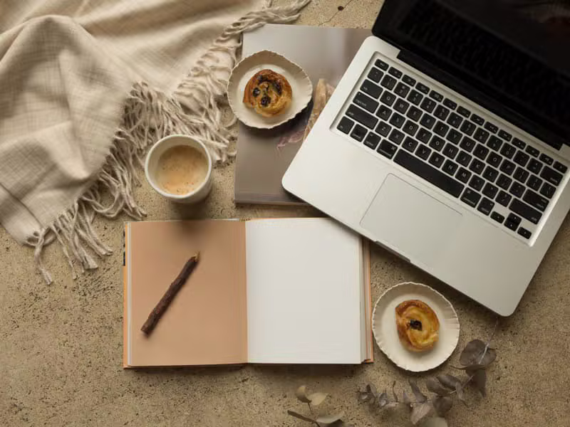 Workspace with laptop showing newsletter analytics