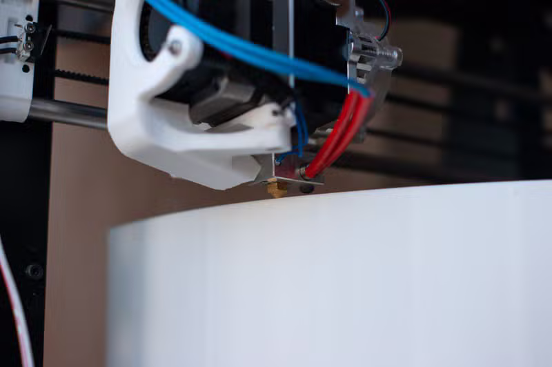 Close up of a modern 3D printer extruder nozzle in action