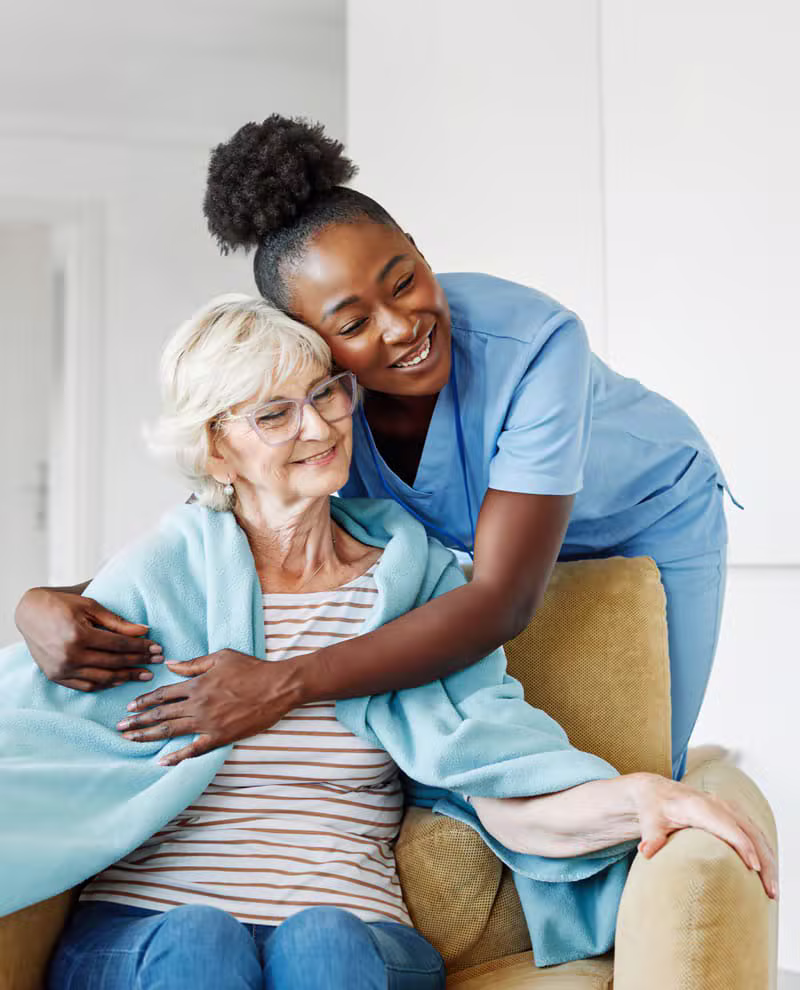 Diverse caregivers helping a white senior patient