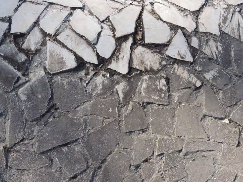 Close up of a concrete finishing trowel creating a smooth texture