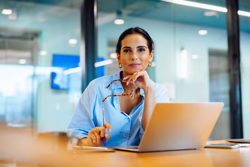Professional working confidently on a laptop