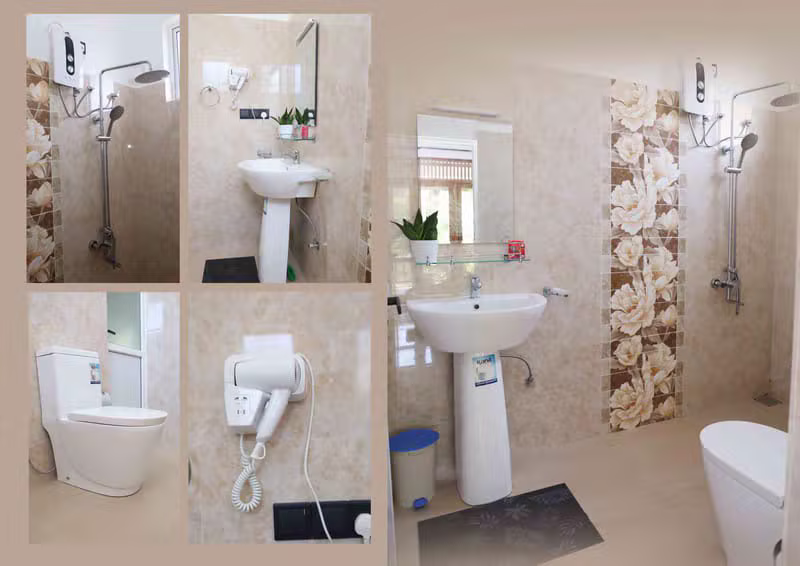 Clean tiled private bathroom with shower and toilet at Mahaweli Haven