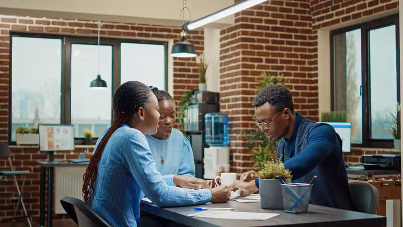 Black African family reviewing a property investment opportunity