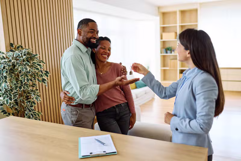 Happy Black African property owner receiving keys