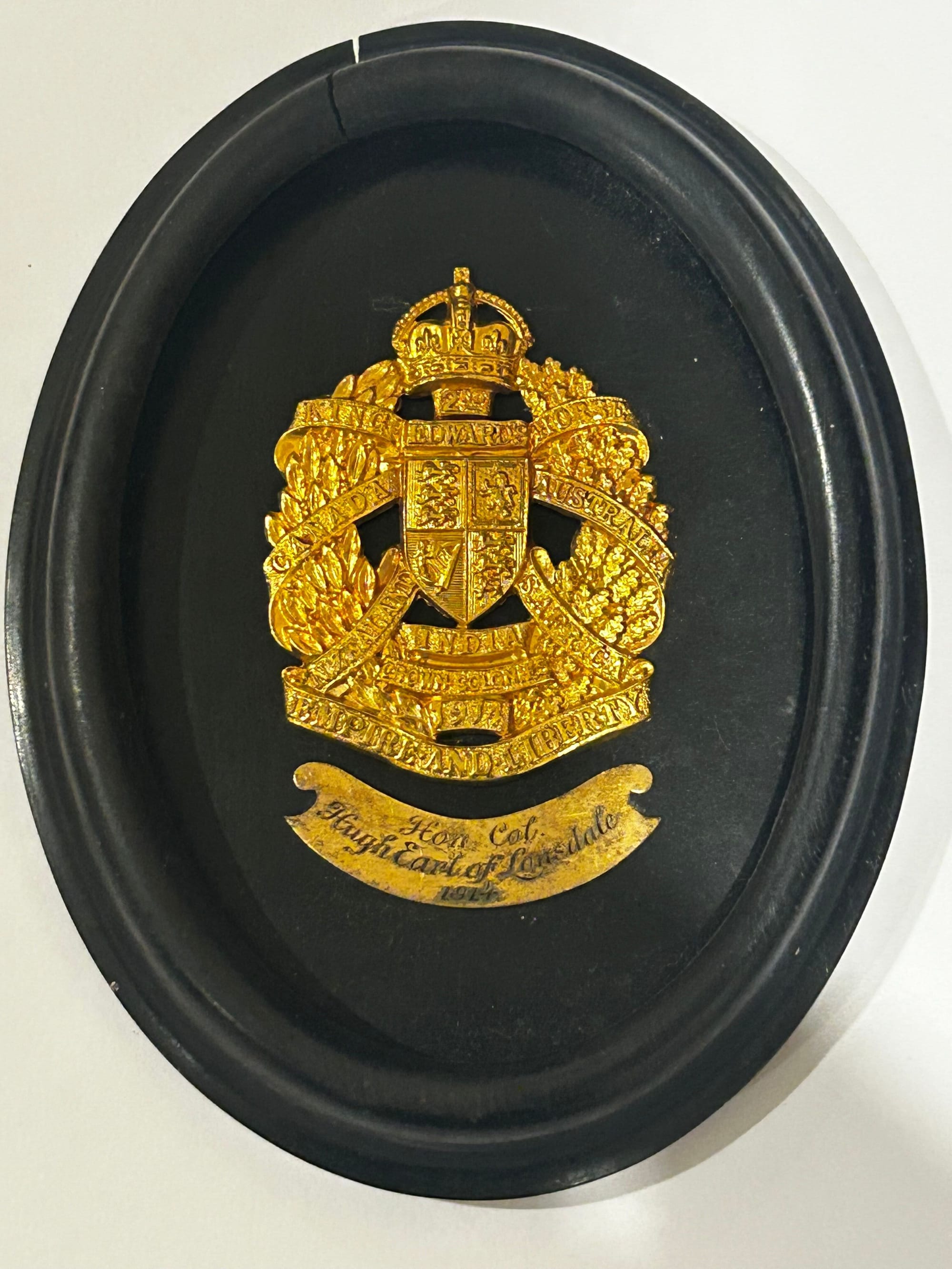 Gilded 2KEH cap badge in an ebony presentation frame presented to Lord Lonsdale, Honorary Colonel of the 2KEH in 1914.