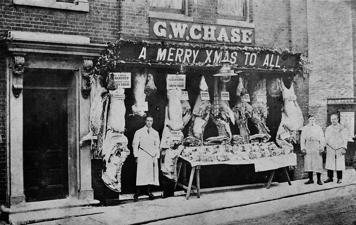 CHASE, Percy. Private. 1894. KEH. KIA at defence of Vieille Chapelle 9/04/1918. Percy stood in teh doorway of his family's butcher shop.  Photograph courtesy of Mary Felgate (great niece).