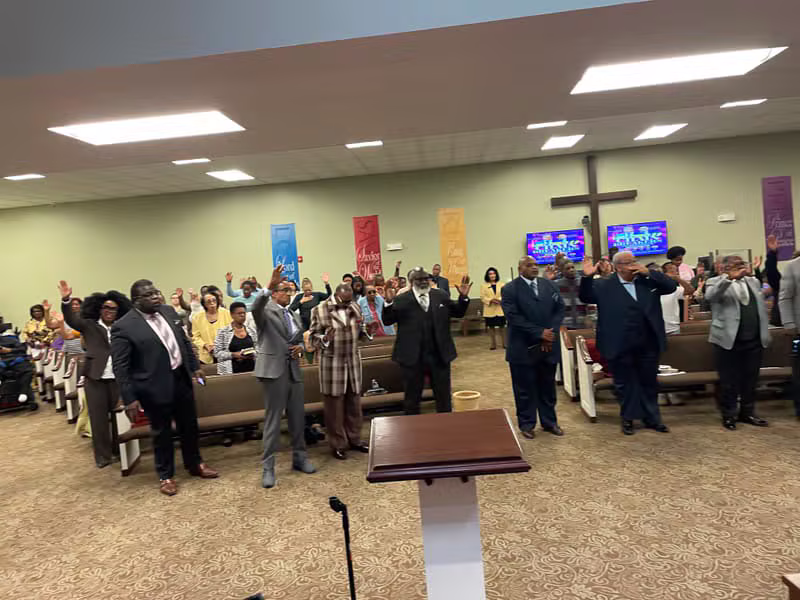 Congregation raising hands in worship