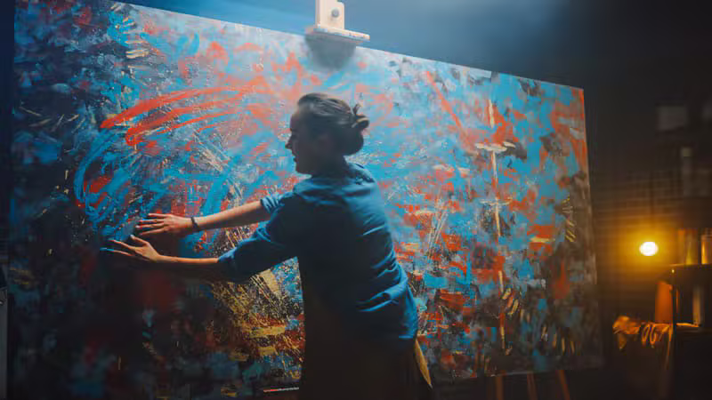 Artist creating a large expressive abstract painting with visible brushstrokes