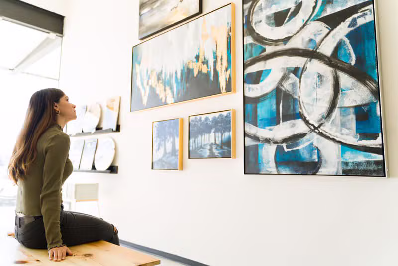 Visitor viewing a large contemporary artwork inside a gallery
