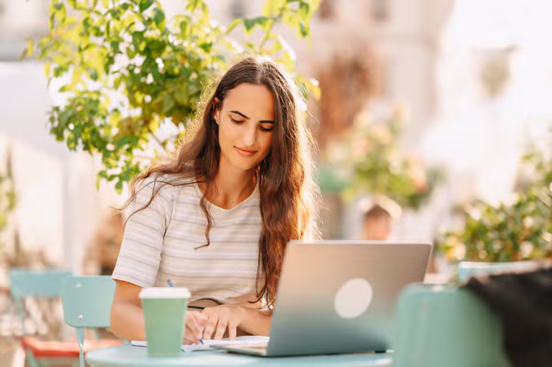 Author writing a manuscript on a laptop