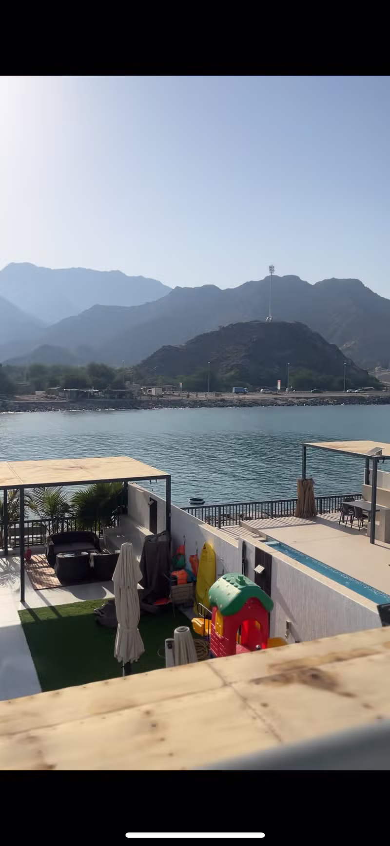 Panoramic sea-side view with calm water and mountains