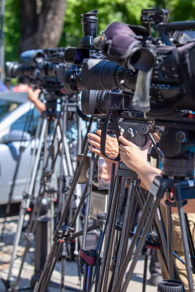Camera crew filming an interview for a digital program