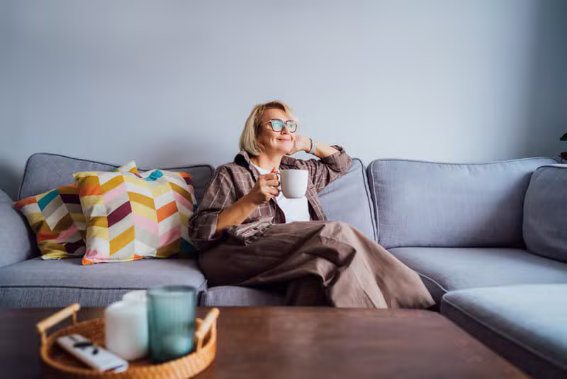 A mature woman cleaning and tidying her home