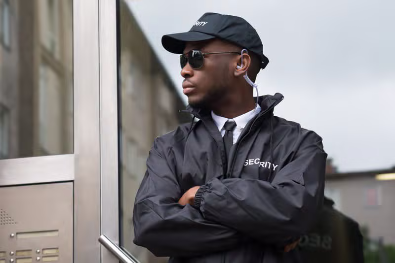 Professional uniformed security guard at a building entrance