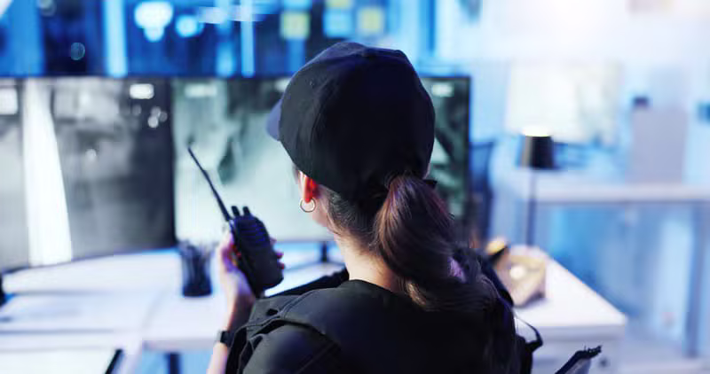 Security officer monitoring surveillance screens