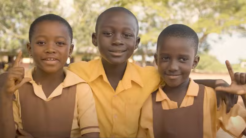 Smiling students in yellow uniforms