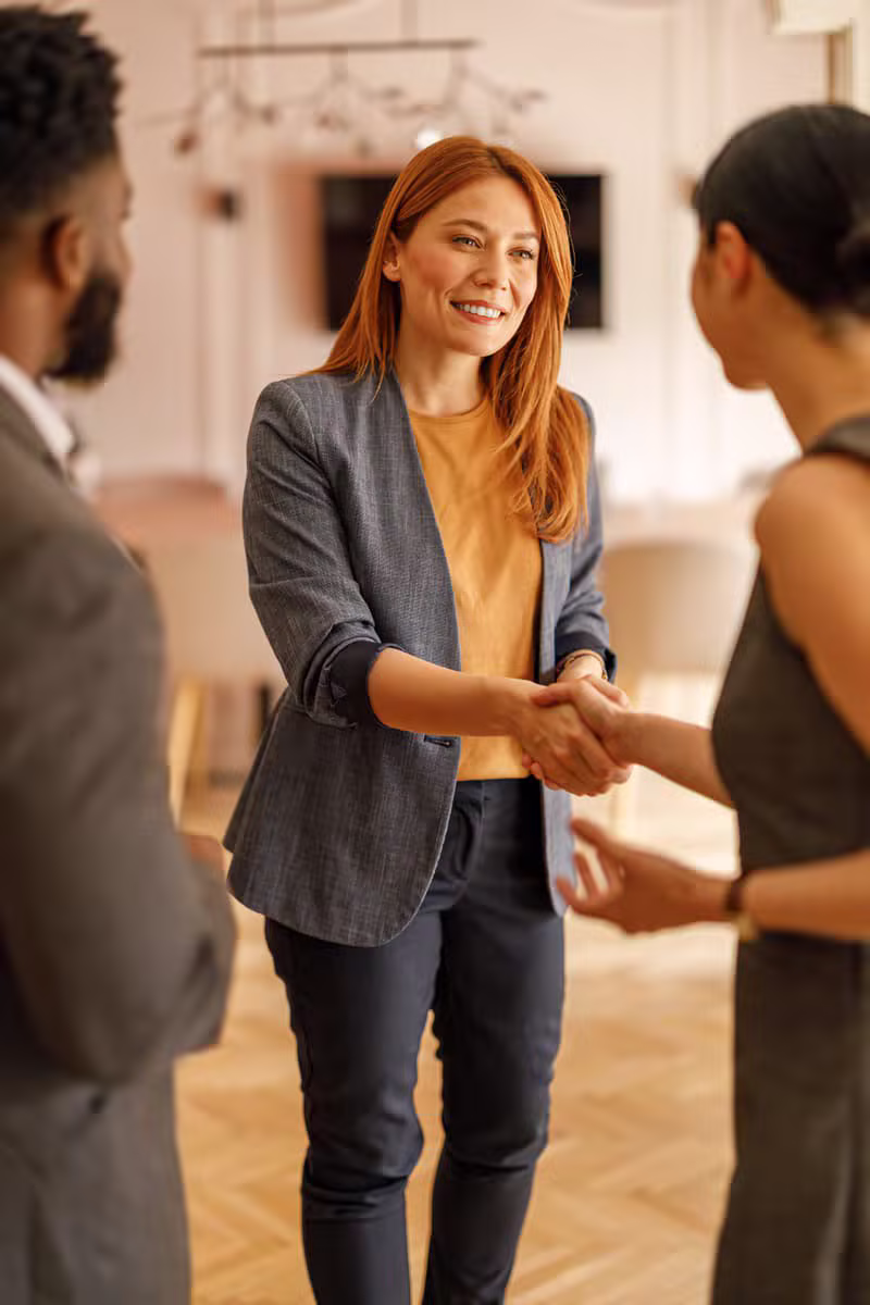 Professionals discussing business financing solutions in a modern office