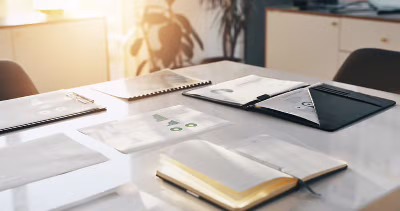 Organized desk with business documents and planners