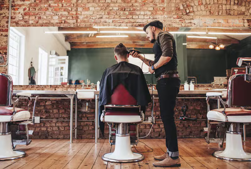 Professional barber working with a client