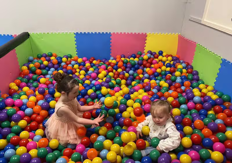 Children playing in the colourful ball pit