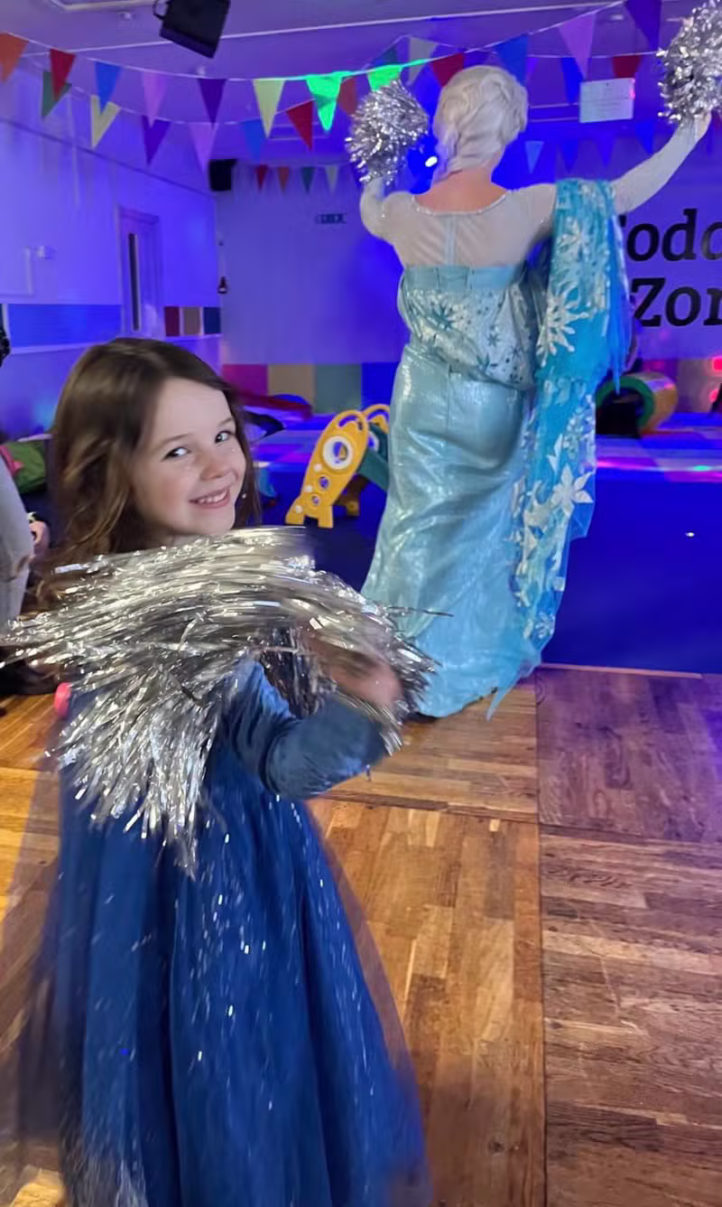 Children enjoying a party disco with a princess character