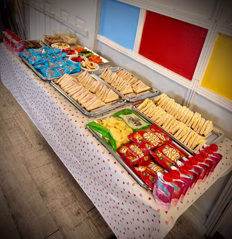 Party buffet table with sandwiches, fruit and snacks