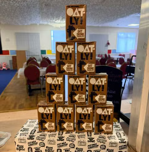A row of oat milk cartons on the café side