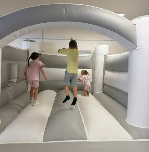 Children climbing and playing on the bouncy castle