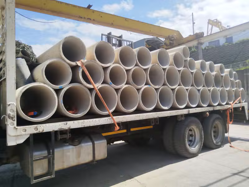 Stack of concrete pipes on a transport truck
