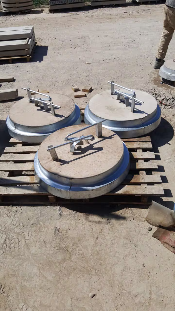 Precast concrete manhole covers stacked on pallets