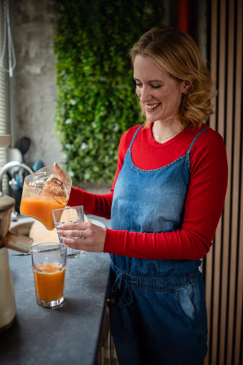 Pouring fresh wellness juice from premium ingredients