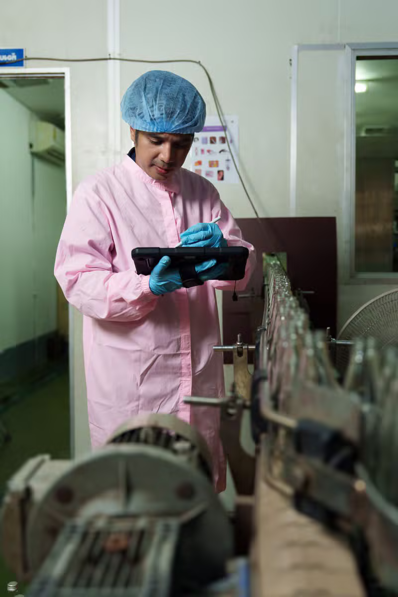 Egyptian food quality engineer inspecting production standards