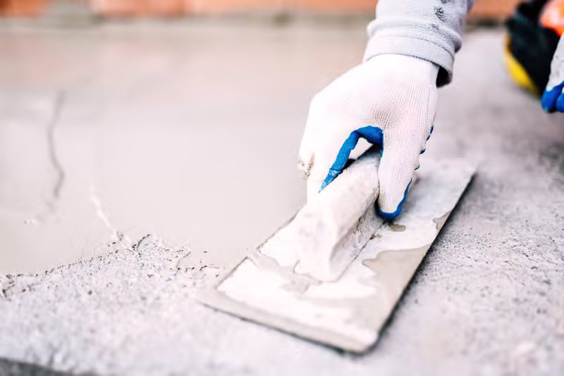 Construction professionals working with concrete
