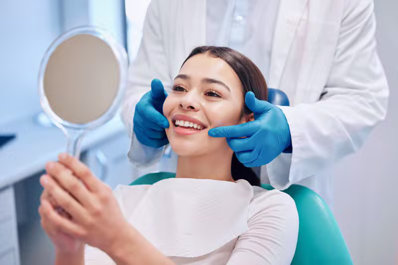 Dentist examining a smiling patient at Dantaa Dental Clinic in Chandigarh
