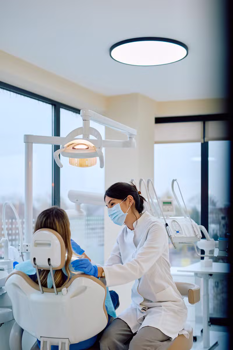 Dentist gently treating a patient at Zaman Dental & Surgery
