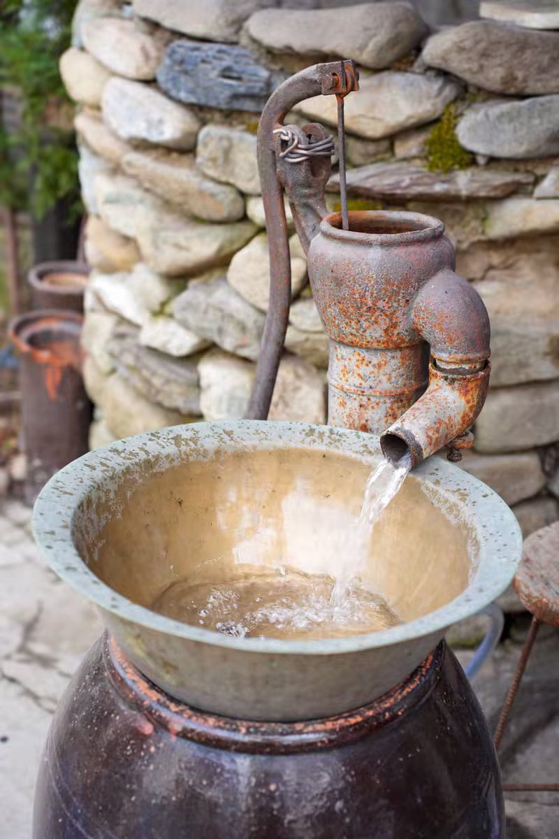 Clean water flowing from a community hand pump