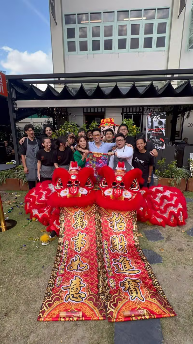 Twin red lions with the troupe holding auspicious banners
