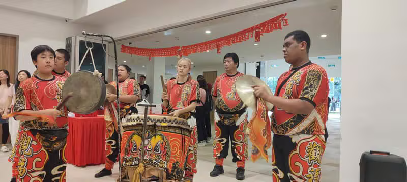 War drum and cymbal team performing in full lion dance costume