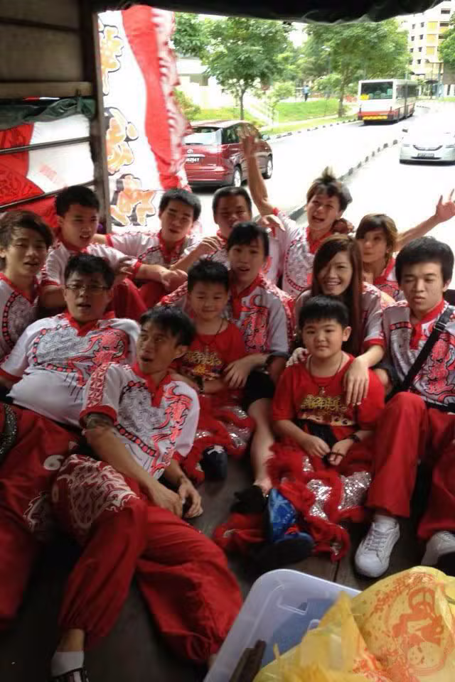 Hong Quan members relaxing with the lion dance team on the lorry between shows