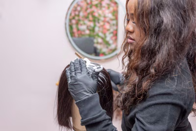 Colour application close-up on Black hair with foils and a colour brush