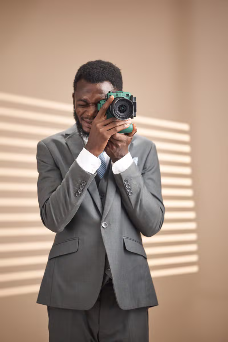 Edeh Obinna Jude, founder and lead photographer at Judestudios, holding his camera