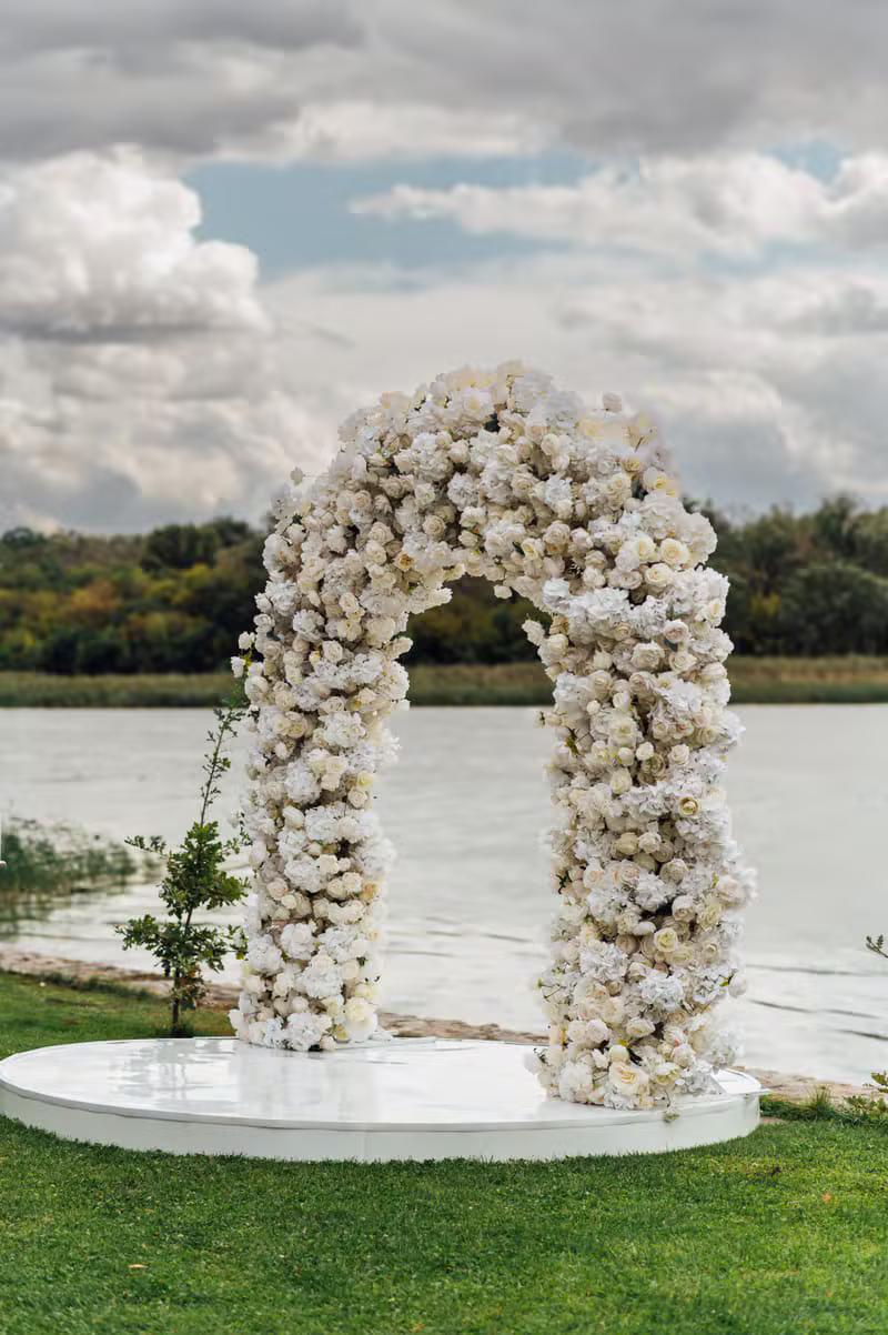 Wedding arch decorated with white and green flowers