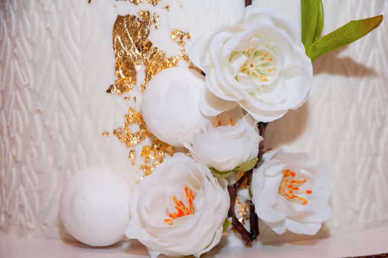 Celebration cake finished with gold accents and flowers