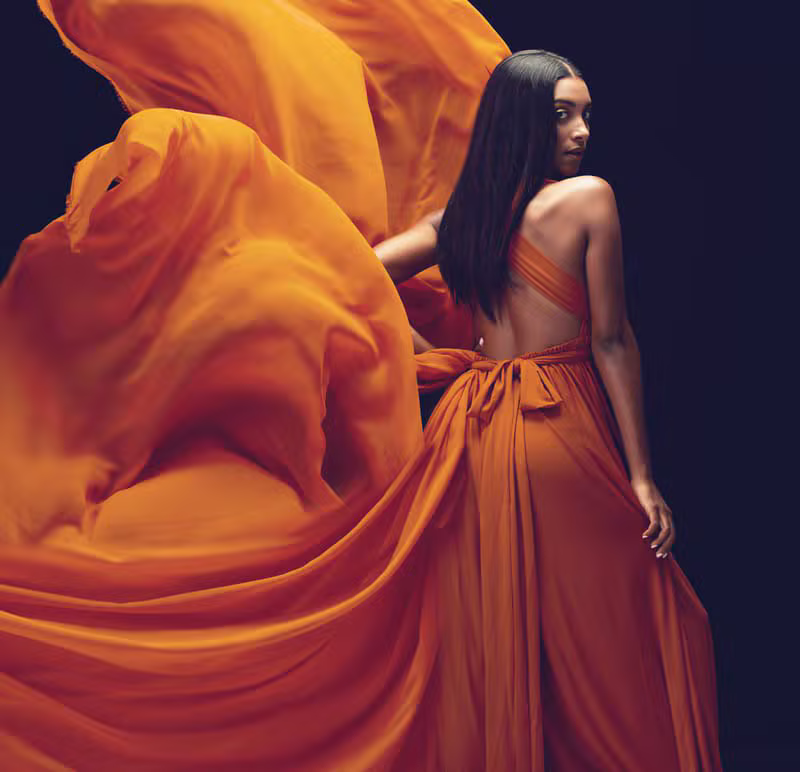 Editorial portrait of a woman in a CAF Collections couture dress