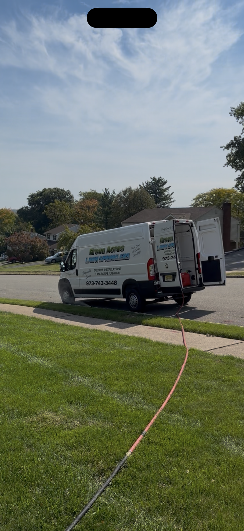 Technician performing a sprinkler system winterization blowout