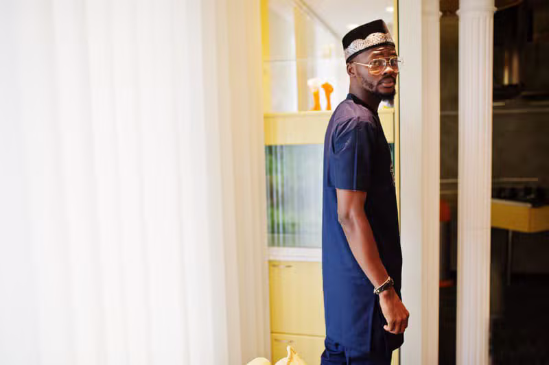 Nigerian male model wearing sophisticated contemporary menswear in a tailoring studio
