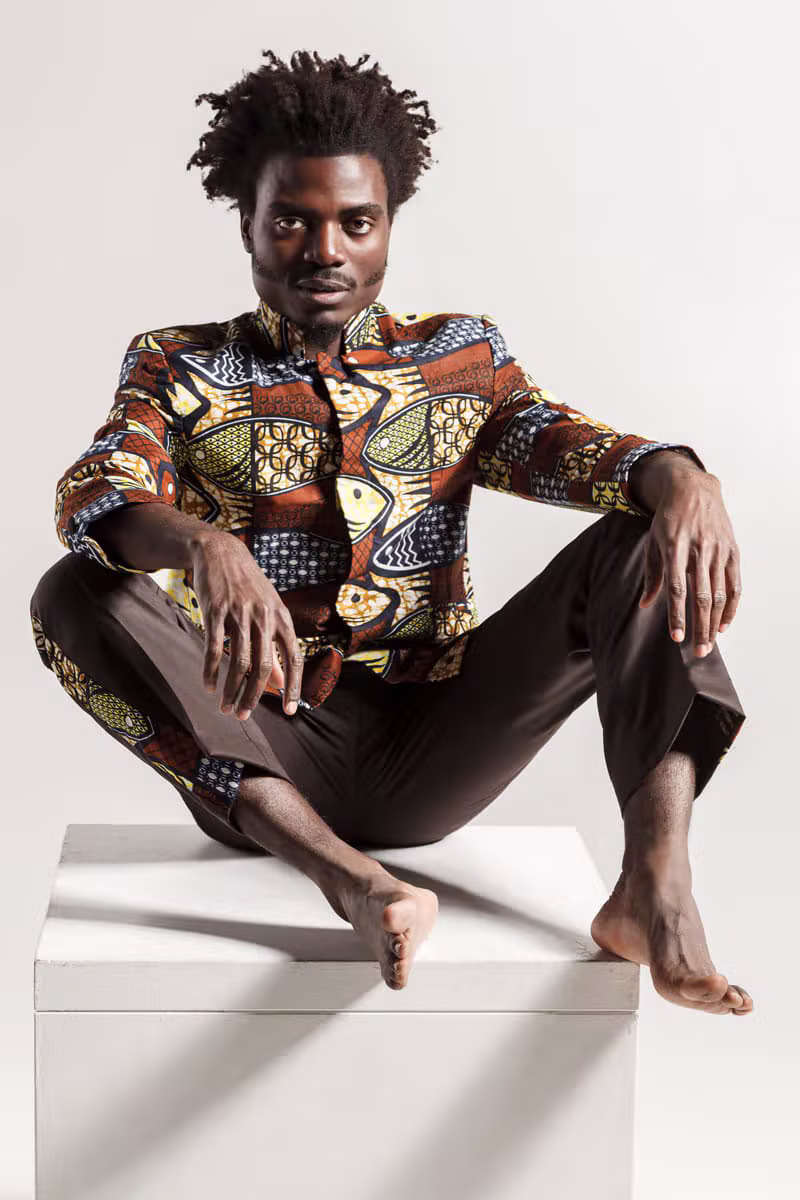 African male model wearing refined contemporary menswear with traditional influence