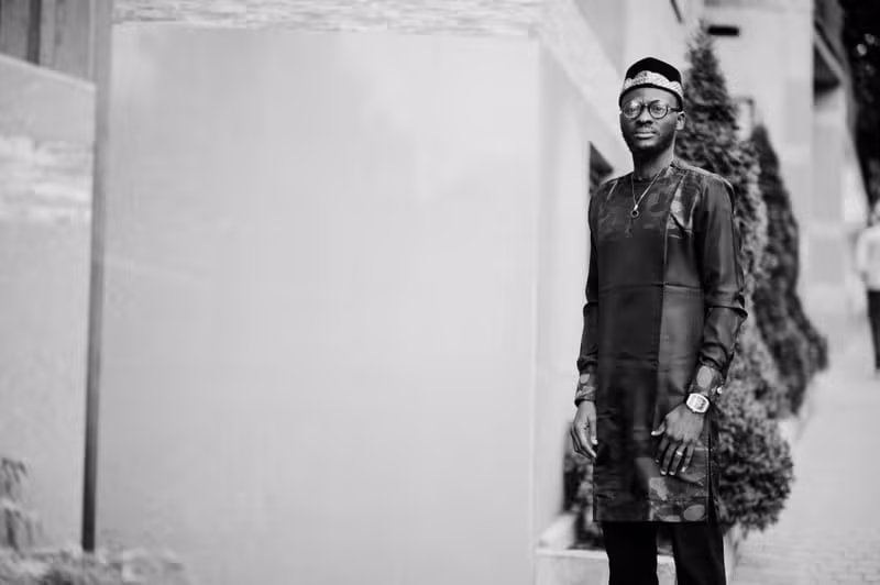 Nigerian male model wearing refined native menswear in contemporary Nigerian architecture