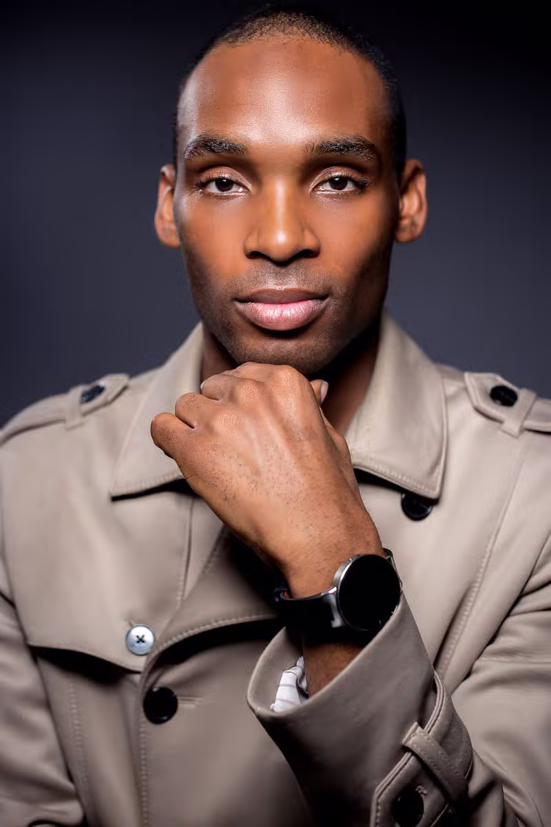 African male model wearing a belted safari jacket suit