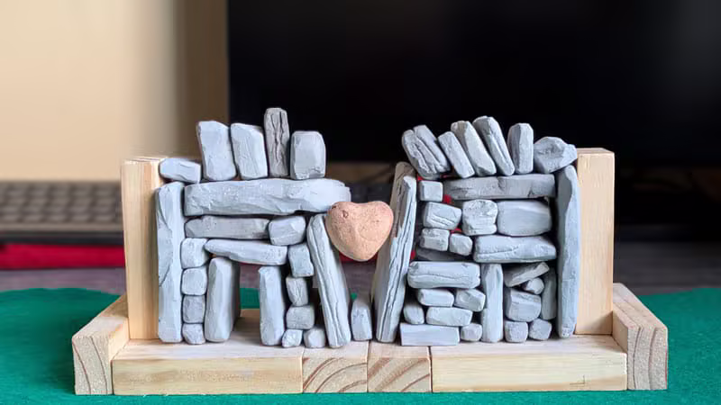 Illustrated dry stone wall with a chintz rose heart stone and the Clocha Croí name